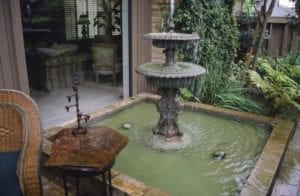 Photograph of a dirty patio fountain.