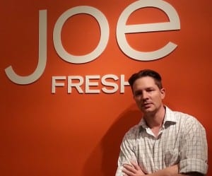 Joe Sirilla in front of Joe Fresh logo.