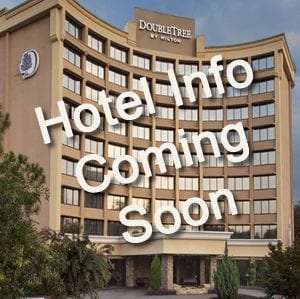 Photograph of a Double Tree by Hilton hotel with text overlay that says "Hotel Info Coming Soon".