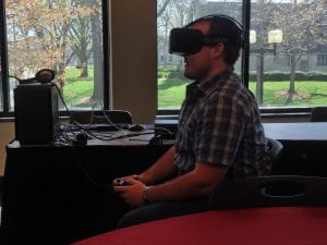 Photograph of student using Oculus Rift at UCM Design & Build day.