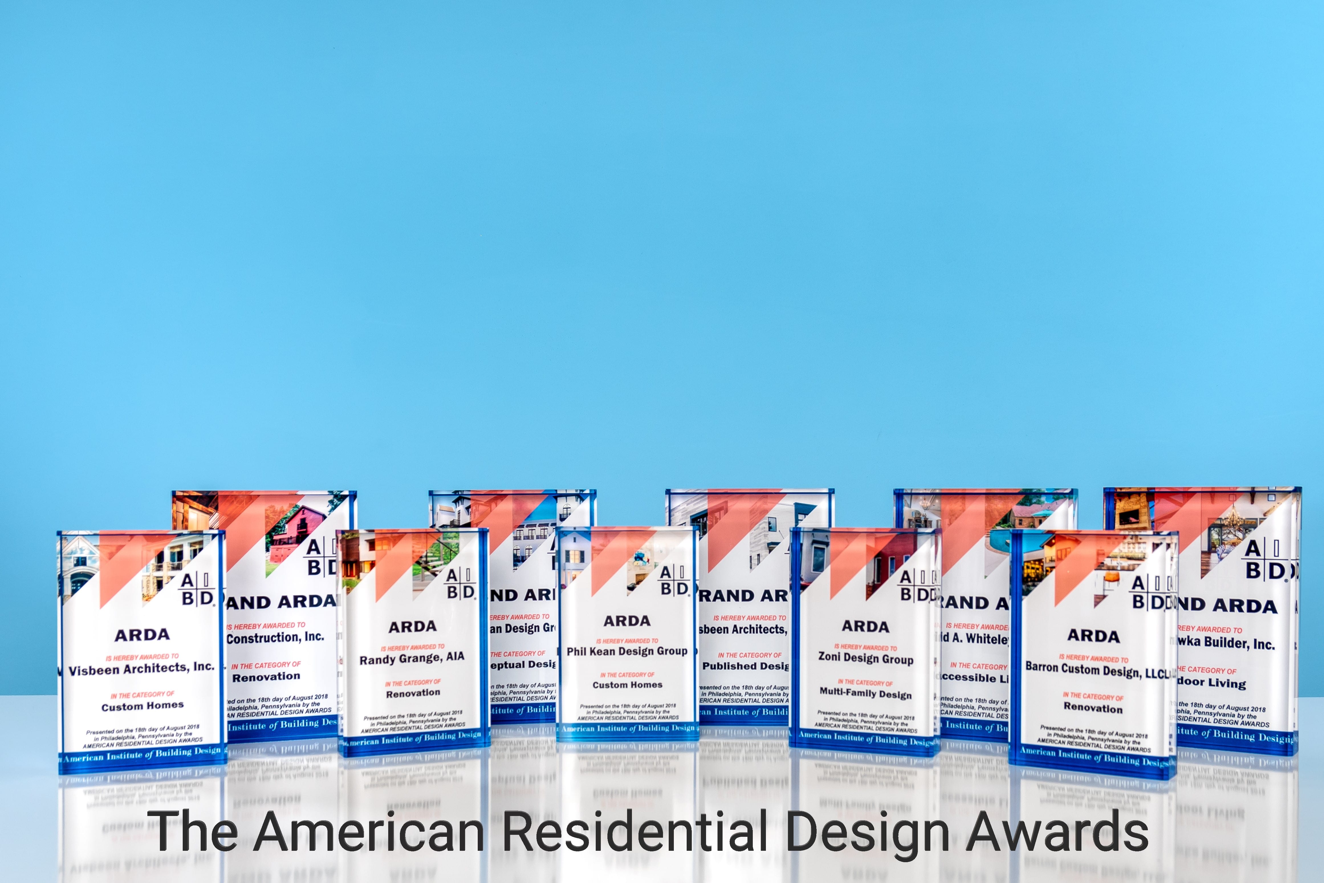 Ten (10) ARDA trophies in a row on a blue background with text below that says The American Residential Design Awards.